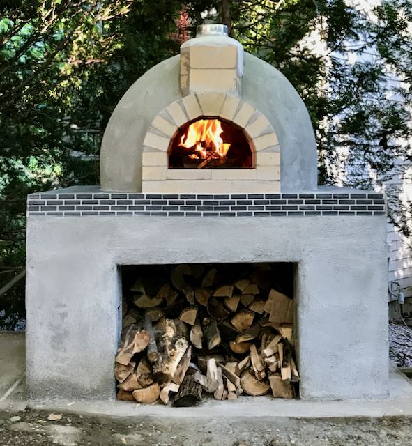 Making a wood fired brick pizza oven : a second firing is done.